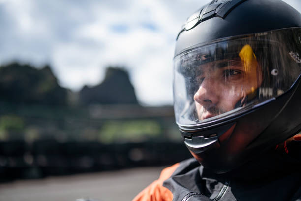 Close-up shot of motorist with his helmet on.